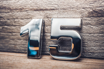 Chrome Number 15 Leaning On A Wooden Wall