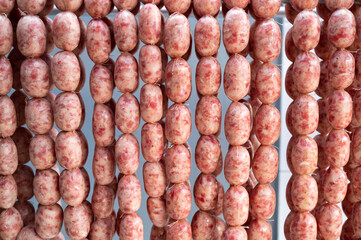 Raw thai sour pork sausage hanging in warehouse