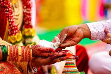 Traditional indian wedding ceremony, groom and bride hand