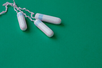 three female tampons lie on a bright background. Feminine hygiene products. Copy space. High quality photo