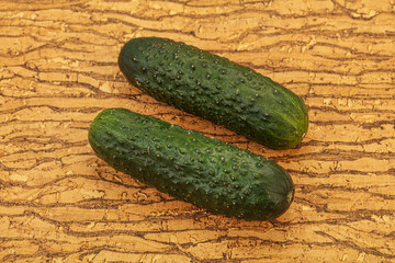 Green fresh cucumbers over background