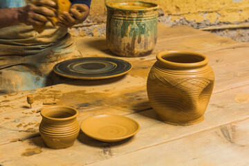 Mexican potter craftsman, working the clay with his hands in his workshop to create sculptures, vases, jugs, vases etc, using traditional methods.