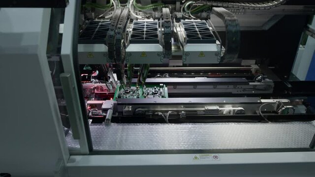 Industrial production of electronics and circuit board. The machine needles are diagnosed and tested. Manufacture of electronic chips. High-tech, The Fourth Industrial Revolution.