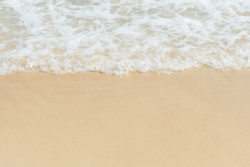 Soft wave of sea on empty sandy beach Background with copy space.