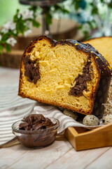 Panettone is the traditional Italian dessert for easter in 2021. Homemade panettone covered in chocolate and sprinkles. Bread served as dessert.