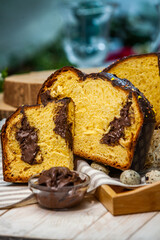 Panettone is the traditional Italian dessert for easter in 2021. Homemade panettone covered in chocolate and sprinkles. Bread served as dessert.