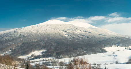 Fototapeta na wymiar Panoramic Image of Polonyna Carynska and Wetlinska Peaks. Snow Covered Bieszczady Mountains in Poland