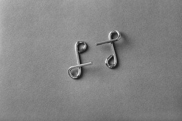 The Wire puzzle (Puzzle ring) on a grey background