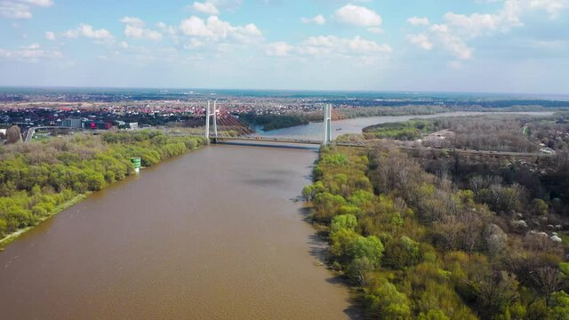 4k footage of high water level in the Vistula River in Warsaw, Poland after intensive spring rainfalls, Siekierkowski Bridge on background