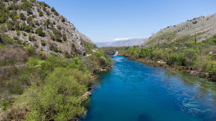 Fototapeta na wymiar Aerial drone view of river in canyon. Mountain river flowing, view from above. Neretva river in Bosnia and Herzegovina.