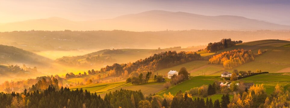 Autumnal Sunrise in Polish Countryside with Rolling Hills at Fall. Large Stitched Panorama. Panoramic Image