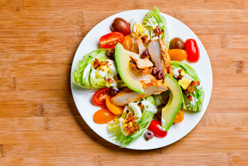 Avocado salad. Classic American salad with iceberg lettuce, blue cheese dressing, red onions, bacon lardons, Parmesan cheese, olive oil, lemon juice, salt and pepper. A Fine dining restaurant classic.