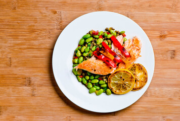 Salmon. Pan roasted Cajun seasoned salmon fillet. Served with rice pilaf, organic steamed vegetables, bell peppers, squash, carrots and zucchini. Classic American diner lunch favorite.