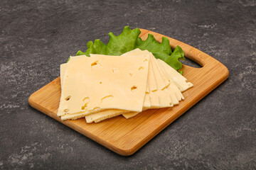 Sliced yellow cheese over board