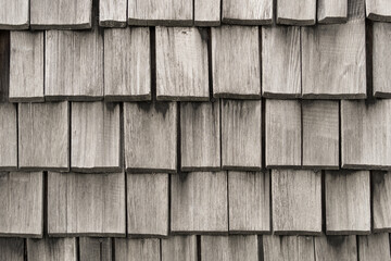 Wood background made of old gray planks. Wooden roof shingle.