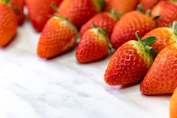still life with strawberries on a white patterned background