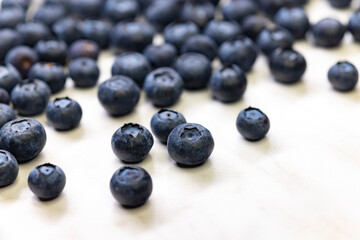 still life with blueberries on a white patterned background