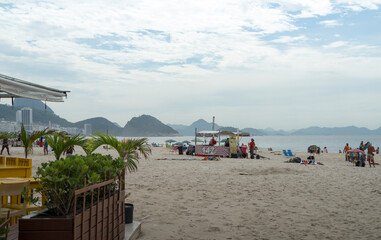 Fototapeta na wymiar Attendants are preparing for the arrival of tourists on Copacabana Beach