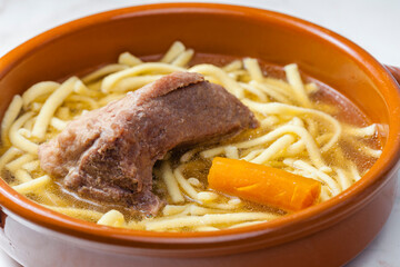 beef bouillon with carrot and noodles