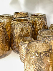 Collection of golden vases against a white background