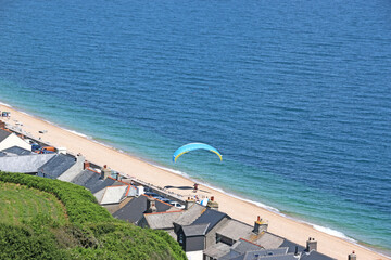 Paraglider landing on Beesands beach in Devon, England	