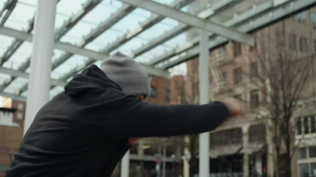 Slow motion shot of a fighter shadowboxing in the city