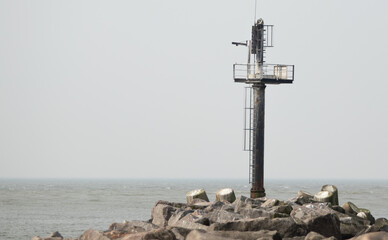 Fototapeta premium Communication tower at the end of pier in Klaipeda habour . 