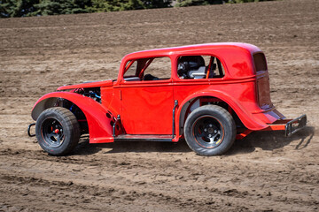 red race car at dirt track