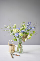 Finished flower arrangement in a vase for home. Flowers bunch, set for interior. Fresh cut flowers for decoration home. European floral shop. Delivery fresh cut flower.