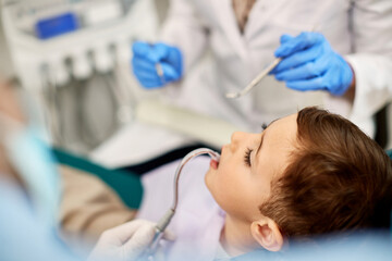 Close-up of child during dental examination at dentist's office.