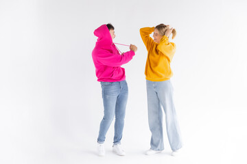 Portrait of cheerful people man and woman in basic clothing smiling and clenching fists like winners or happy people isolated over white background