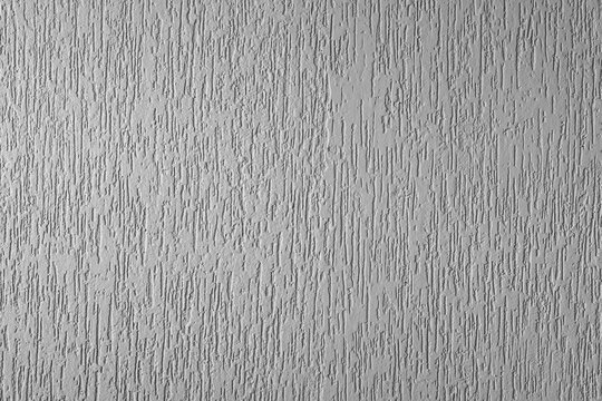 Plastered surface of a wall with light gray grooves. in Brazil known as grafiato. horizontal cut