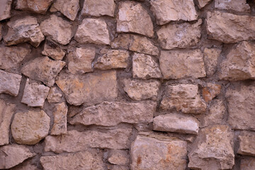 Surface of masonry wall of pink stone