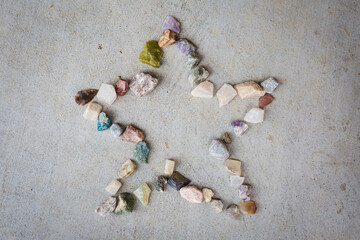 Star made by a child out of rocks and gems