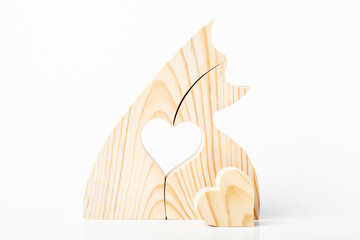 Figurine of embracing cats, carved from solid pine by hand jigsaw. On a white background