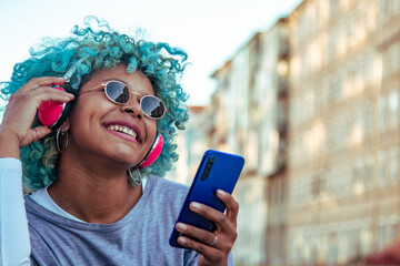Fototapeta premium afro american girl with headphones and mobile phone