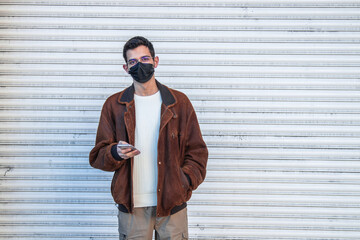 man with mask and mobile phone on the street