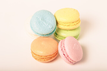 Colorful cake macaroons on a light background. Toned