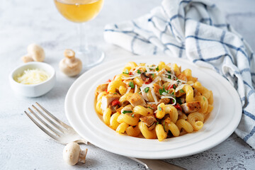 Roasted chicken mushroom pepper pasta in a white plate