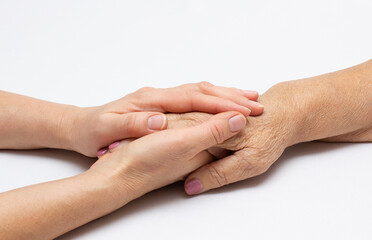Fototapeta premium old and young hands; offering comfort care