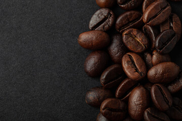 Roasted coffee beans on the black background for wallpaper or decor