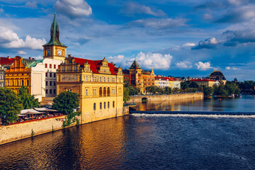 Fototapeta premium Prague in a sunny day, view of the old town, Prague, Czech Republic. Scenic summer view of the Old Town pier architecture and Charles Bridge over Vltava river in Prague, Czech Republic