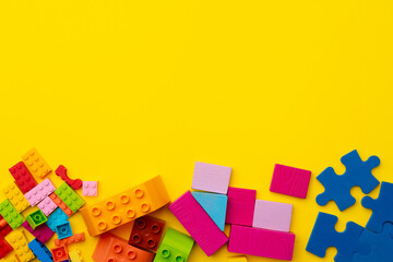 Toy kid's constructor on yellow background top view