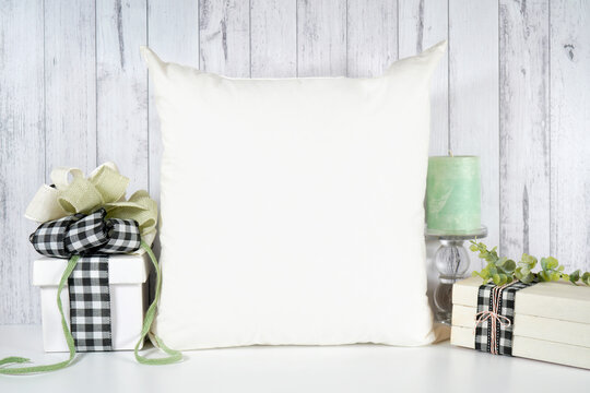 White throw pillow cushion. Farmhouse craft product mockup with farmhouse style decor, gifts and stack of books for Mother's Day, Father's Day, Birthdays, and Anniversaries. Negative copy space.