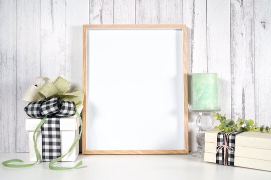 Art poster print wooden frame. Farmhouse craft product mockup with farmhouse style decor, gifts and stack of books for Mother's Day, Father's Day, Birthdays, and Anniversaries. Negative copy space.