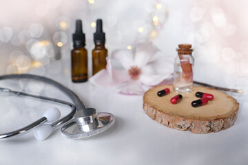 capsules, medical stethoscope, creating a new medicine from plants, gifts of nature, dietary supplements, magnolia flowers, concept science, genetic engineering, natural medicine, pharmacology