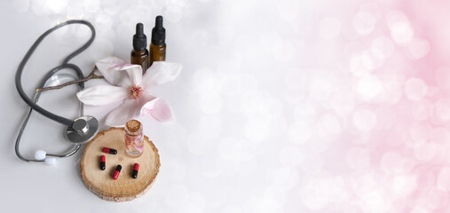 capsules, medical stethoscope, creating a new medicine from plants, gifts of nature, dietary supplements, magnolia flowers, concept science, genetic engineering, natural medicine, pharmacology, banner