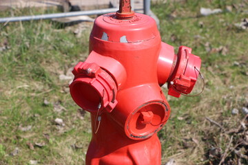 A typical american red fire hydrant in the rural street