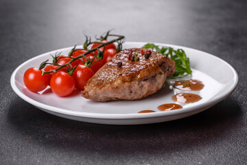 Baked duck breast with herbs and spices on a dark concrete background