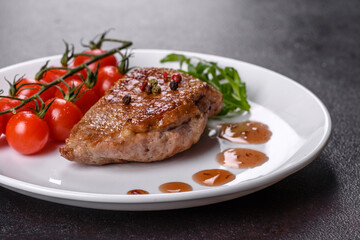 Baked duck breast with herbs and spices on a dark concrete background